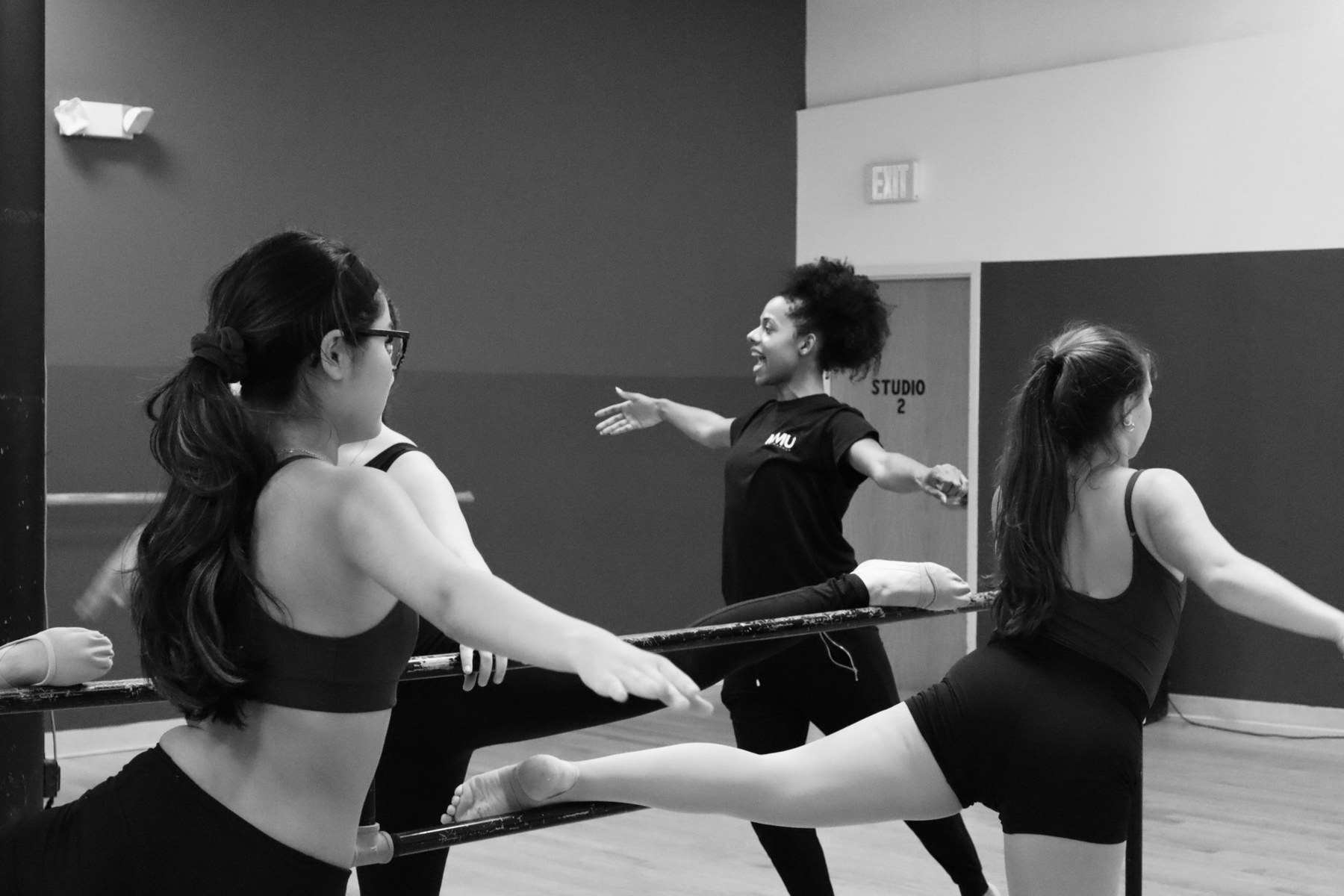 A teacher demonstrating at the barre